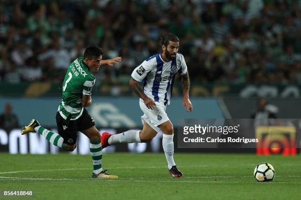 Porto's midfielder Sergio Oliveira from Portugal tries to escape Jonathan Silva during the Portuguese Primeira Liga round two match between Sporting...