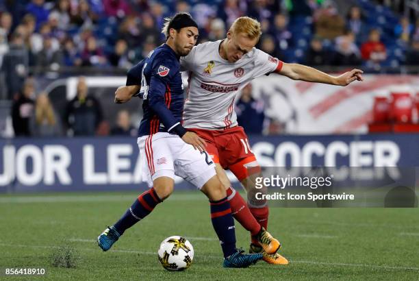 Atlanta United FC midfielder Jeff Larentowicz muscles in on New England Revolution midfielder Lee Nguyen during a match between the New England...