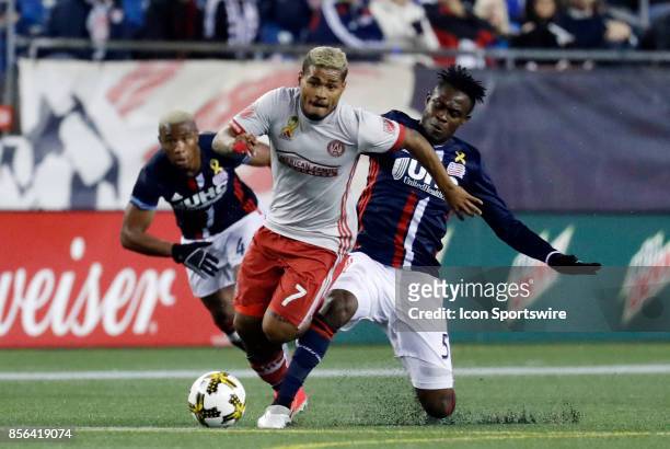 Atlanta United FC forward Josef Martinez escapes the tackle from New England Revolution midfielder Gershon Koffie during a match between the New...