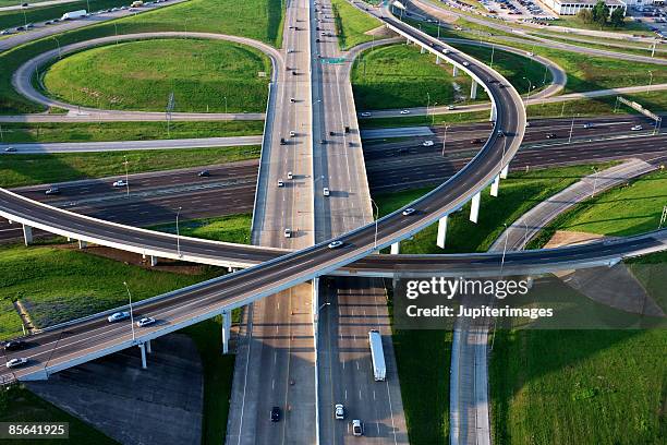 aerial view of clover leaf interchange - straßenüberführung stock-fotos und bilder