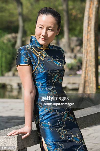 woman wearing cheongsam - silk china stock pictures, royalty-free photos & images