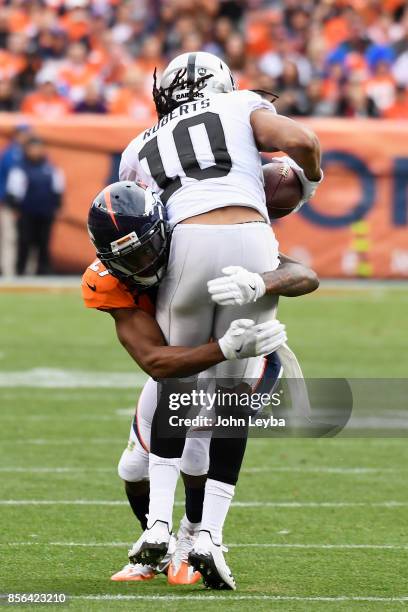 Seth Roberts of the Oakland Raiders is tackled by Bradley Roby of the Denver Broncos in the fourth quarter. The Denver Broncos hosted the Oakland...