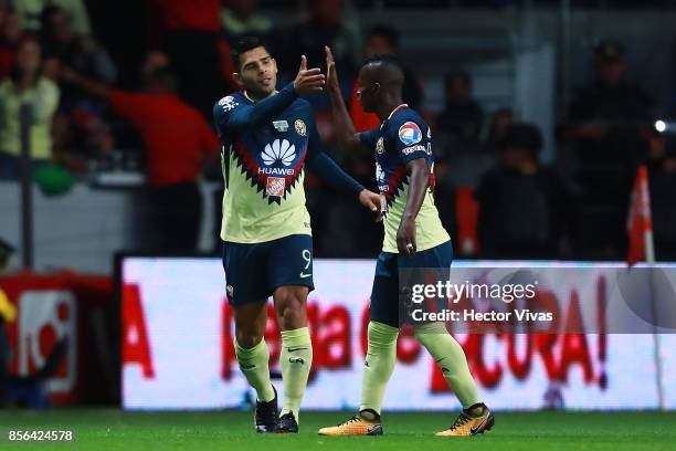 Silvio Romero of America celebrates with teammates after scoring the first goal of his team during the 12th round match between Toluca and America as...