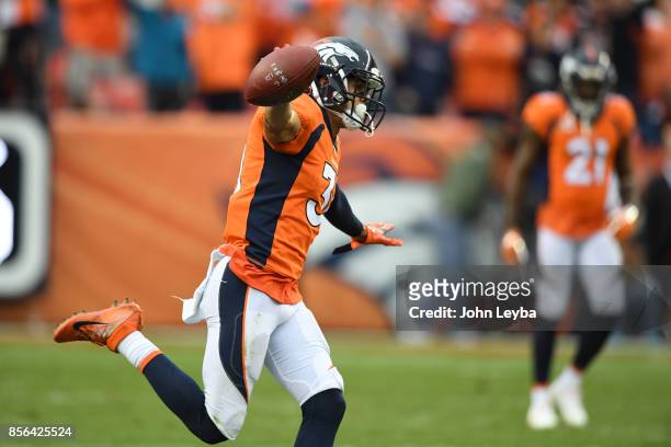 Justin Simmons of the Denver Broncos celebrates an interception in the fourth quarter of the game against the Oakland Raiders. The Denver Broncos...