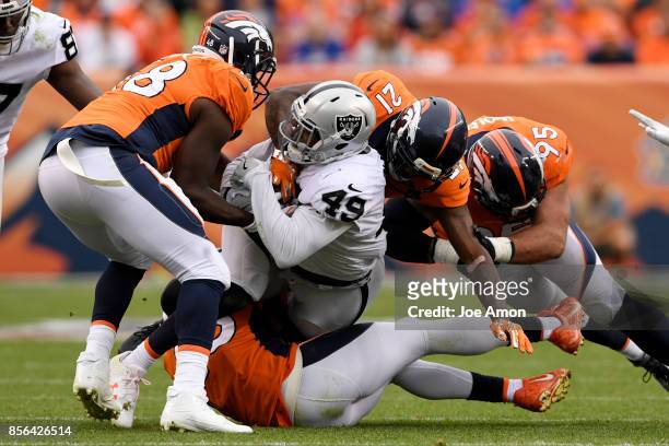Jamize Olawale of the Oakland Raiders is mobbed by the Denver Broncos defense during the fourth quarter of the Broncos' 16-10 win on Sunday, October...