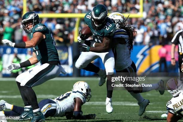 Jahleel Addae of the Los Angeles Chargers tackles Wendell Smallwood of the Philadelphia Eagles during the NFL game at StubHub Center on October 1,...