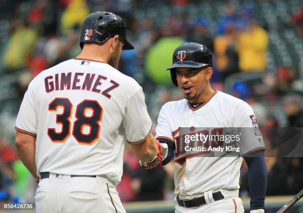 Chris Gimenez of the Minnesota Twins is congratulated by Eduardo Escobar of the Minnesota Twins after hitting a home run against the Detroit Tigers...