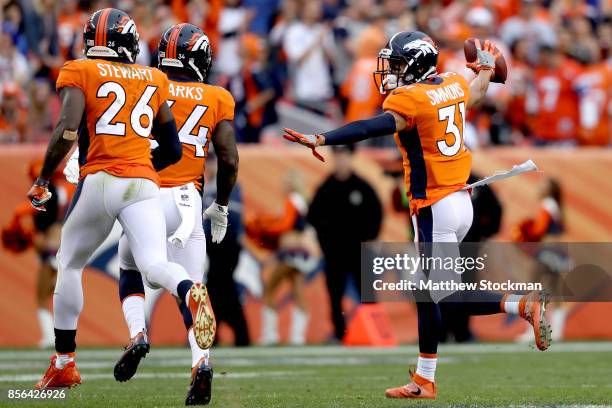 Justin Simmons of the Denver Broncos celebrates making an interception late in the fourth quarter against the Oakland Raiders at Sports Authority...