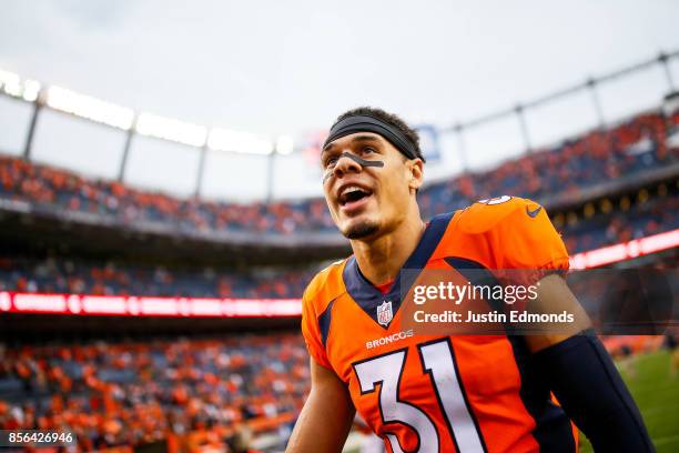 Strong safety Justin Simmons of the Denver Broncos smiles as he walks off the field after a 16-10 win over the Oakland Raiders at Sports Authority...