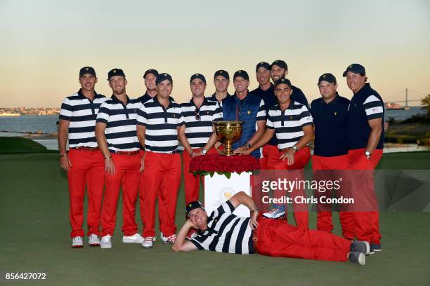 Members of the U.S. Team pose with the trophy after they defeated the International Team 19 to 11 in the Presidents Cup at Liberty National Golf Club...