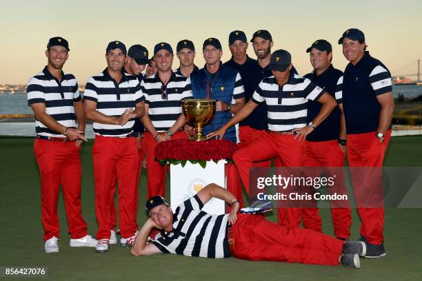 Members of the U.S. Team pose with the trophy after they defeated the International Team 19 to 11 in the Presidents Cup at Liberty National Golf Club...