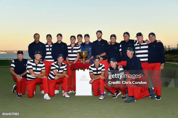 Members of the U.S. Team pose with the trophy after they defeated the International Team 19 to 11 in the Presidents Cup at Liberty National Golf Club...