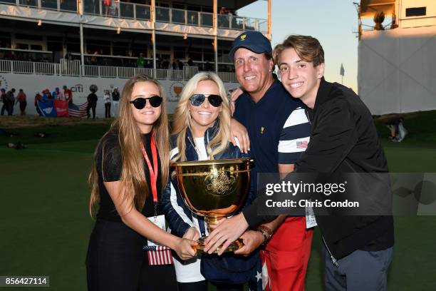 Phil Mickelson of the U.S. Team, wife Amy Mickelson, son Evan and daughter Sophia celebrate with the trophy after the U.S. Team defeated the...