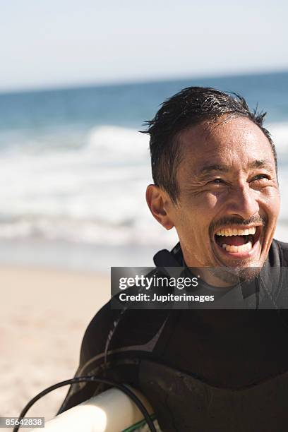 happy surfer at beach - pacific islander ethnicity 個照片及圖片檔