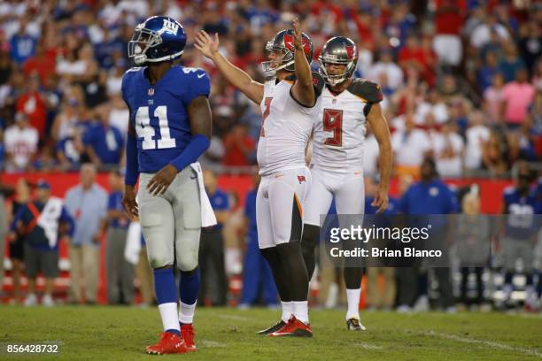 Kicker Nick Folk of the Tampa Bay Buccaneers celebrates as he and punter Bryan Anger join cornerback Dominique Rodgers-Cromartie of the New York...