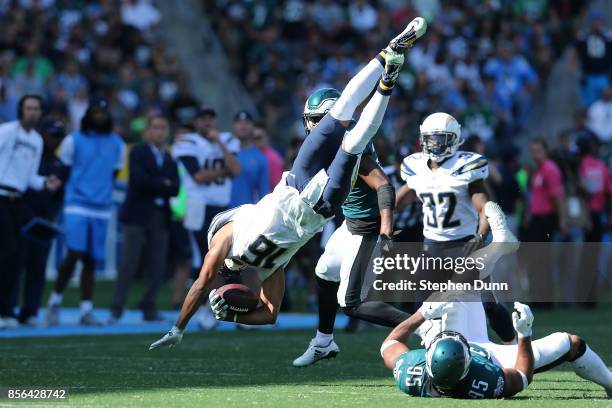 Tyrell Williams of the Los Angeles Chargers leaps over Mychal Kendricks of the Philadelphia Eagles during the NFL game at StubHub Center on October...