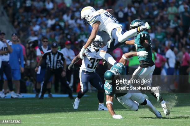 Tyrell Williams of the Los Angeles Chargers leaps over Mychal Kendricks of the Philadelphia Eagles during the NFL game at StubHub Center on October...
