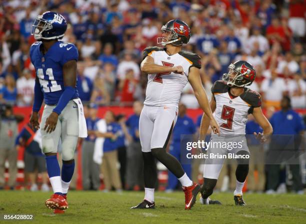 Kicker Nick Folk of the Tampa Bay Buccaneers and punter Bryan Anger join cornerback Dominique Rodgers-Cromartie of the New York Giants in watching...