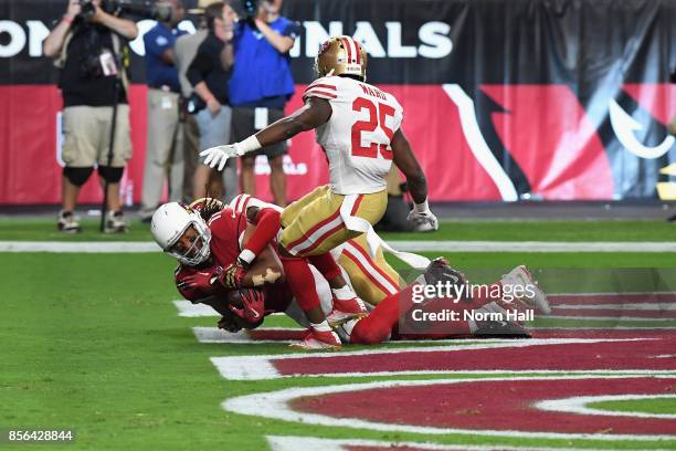Wide receiver Larry Fitzgerald of the Arizona Cardinals makes the game winning catch in the end zone over cornerback Jimmie Ward of the San Francisco...