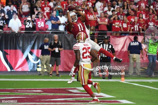 Wide receiver Larry Fitzgerald of the Arizona Cardinals makes the game winning catch in the end zone during overtime in the NFL game against the San...