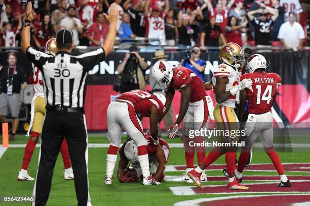 Wide receiver Jaron Brown and running back Chris Johnson celebrate with teammate wide receiver Larry Fitzgerald of the Arizona Cardinals after his...