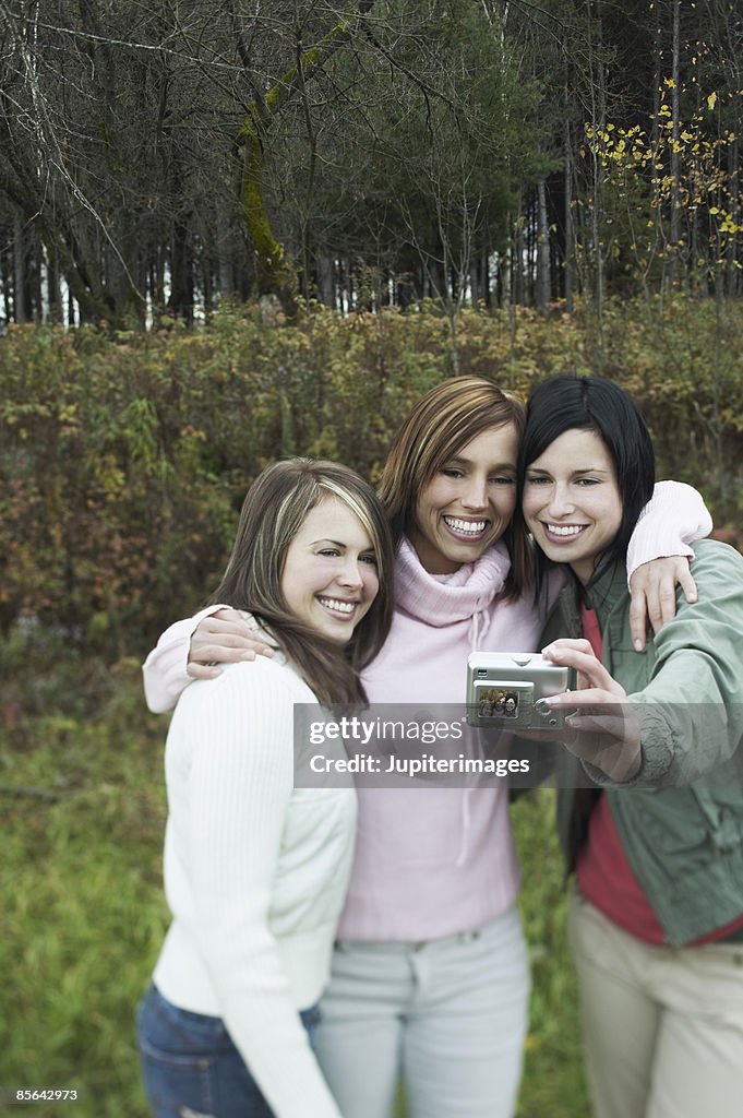 Three friends posing for picture