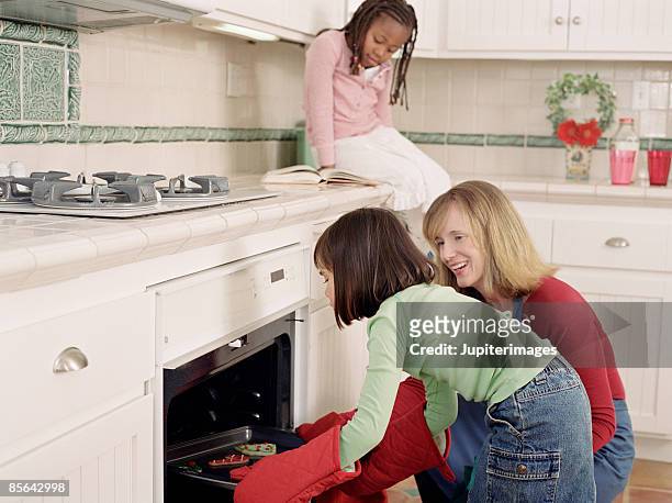 woman and girls baking together - hot filipina women stock pictures, royalty-free photos & images
