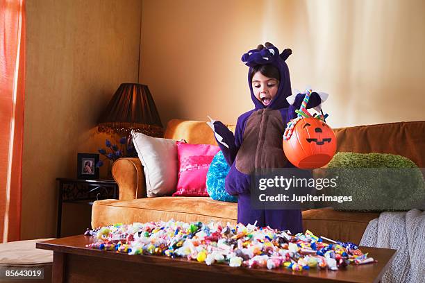 girl with halloween candy - bonbons stockfoto's en -beelden