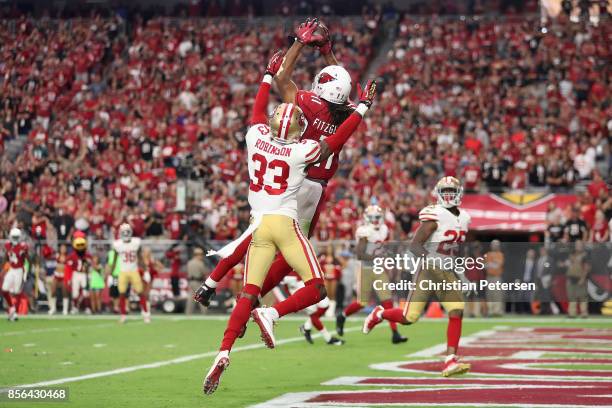 Wide receiver Larry Fitzgerald of the Arizona Cardinals catches the game-winning touchdown in overtime over cornerback Rashard Robinson of the San...