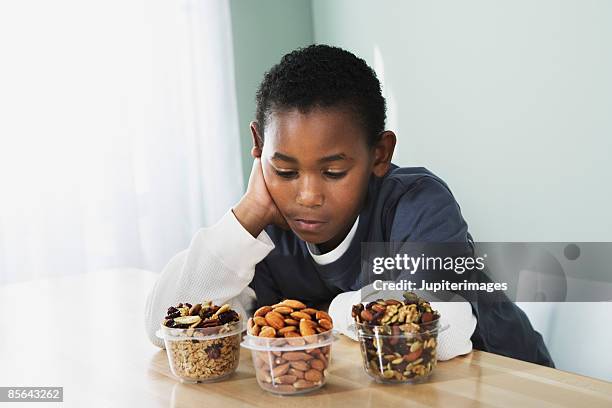 boy choosing a snack - trail mix stock pictures, royalty-free photos & images