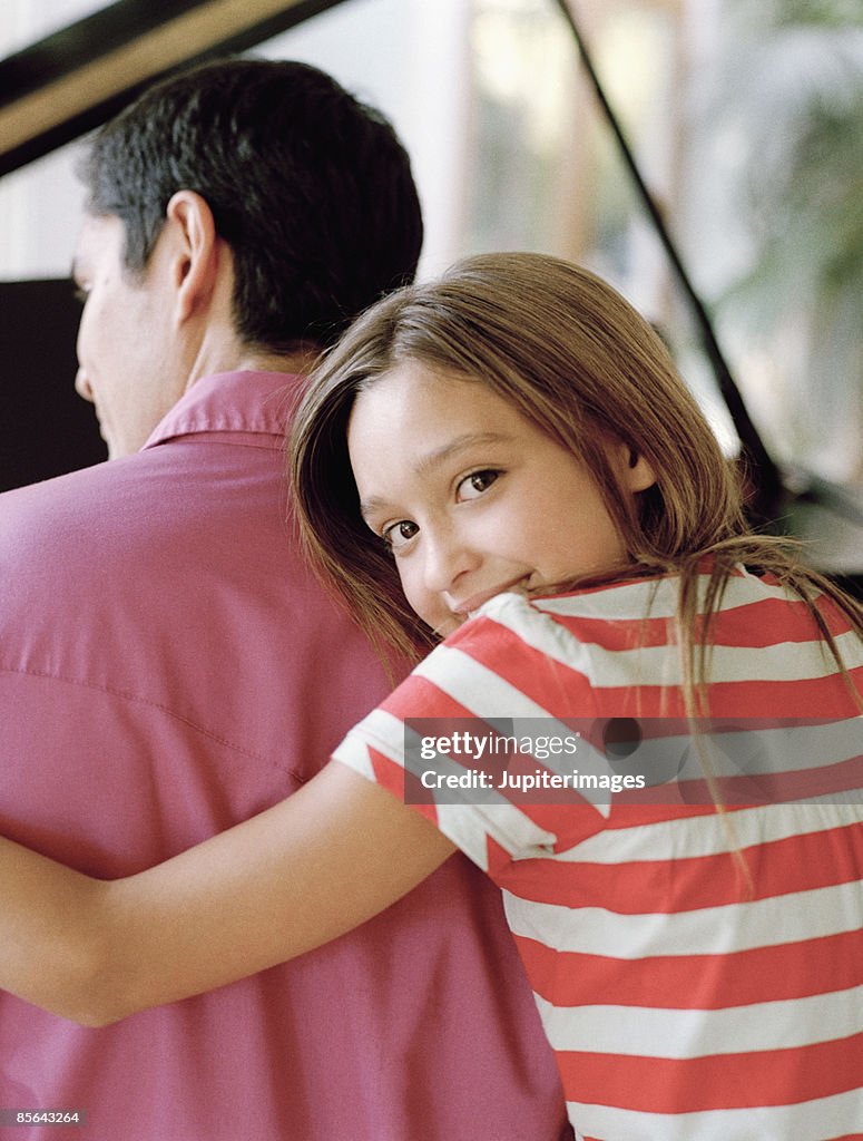 Daughter embracing father