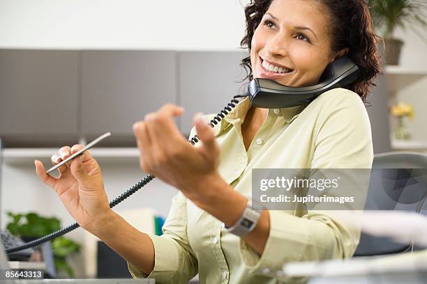 woman talking on phone and filing nails - nail file stock pictures, royalty-free photos & images