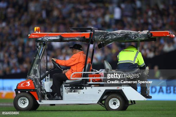 Shaun Fensom of the Cowboys is assited by team trainers after an injury during the 2017 NRL Grand Final match between the Melbourne Storm and the...