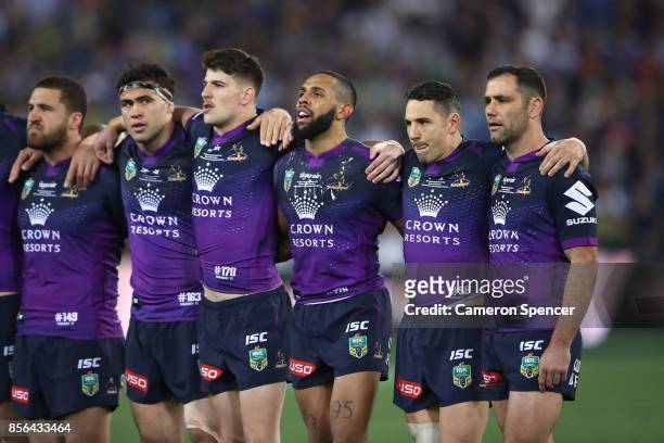 Storm players sing the national anthem before the 2017 NRL Grand Final match between the Melbourne Storm and the North Queensland Cowboys at ANZ...