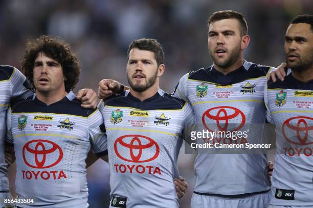 Jake Granville, Lachlan Coote, Kyle Feldt and Justin O'Neill of the Cowboys sing the national anthem before the 2017 NRL Grand Final match between...