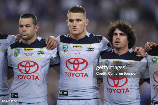 Shaun Fensom, Coen Hess and Jake Granvillel of the Cowboys sing the national anthem before the 2017 NRL Grand Final match between the Melbourne Storm...