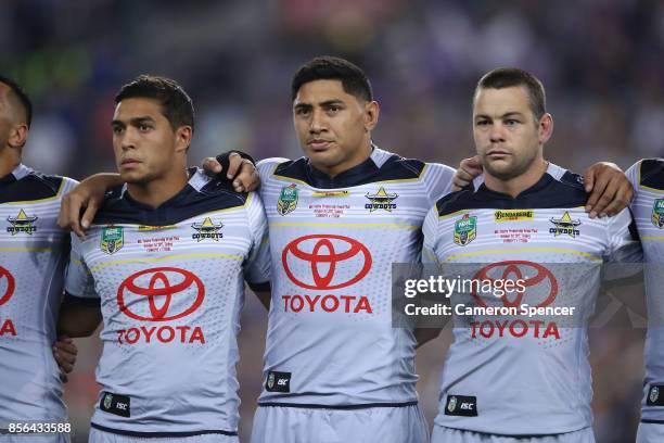 Te Maire Martin, Jason Taumalolo and Shaun Fensom of the Cowboys sing the national anthem before the 2017 NRL Grand Final match between the Melbourne...