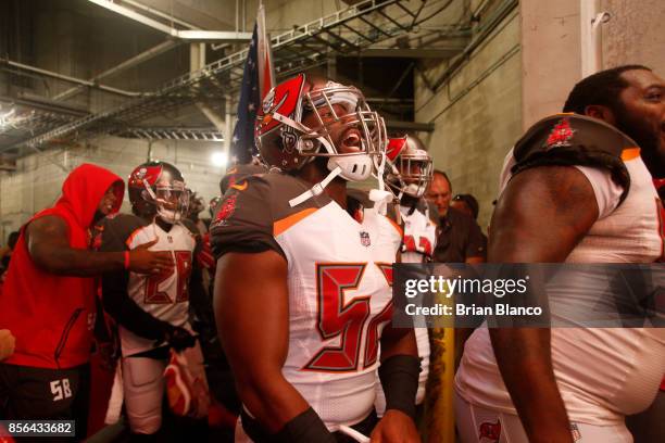 Linebacker Cameron Lynch of the Tampa Bay Buccaneers yells in the tunnel before taking to the field with teammates before the start of an NFL...