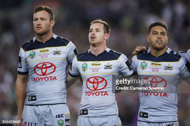 Gavin Cooper, Michael Morgan and Antonio Winterstein of the Cowboys sing the national anthem before the 2017 NRL Grand Final match between the...