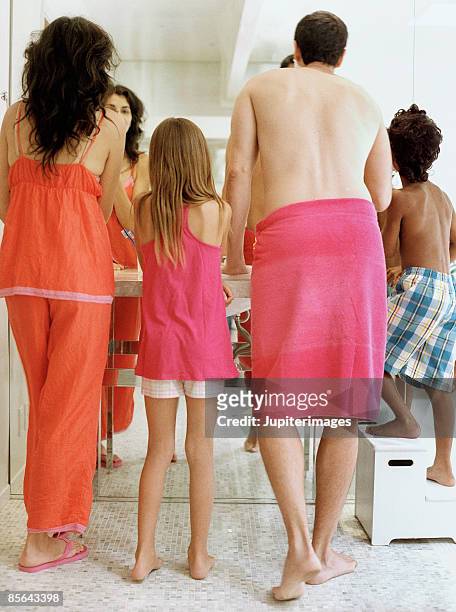 family standing in bathroom - semi dress stock pictures, royalty-free photos & images