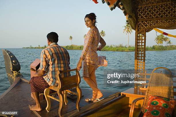 couple navigating houseboat, india - mid adult women stock pictures, royalty-free photos & images