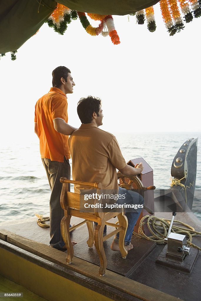 Men together on houseboat, India