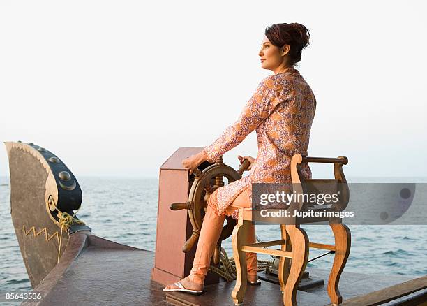 woman navigating houseboat, india - mid adult women stock pictures, royalty-free photos & images