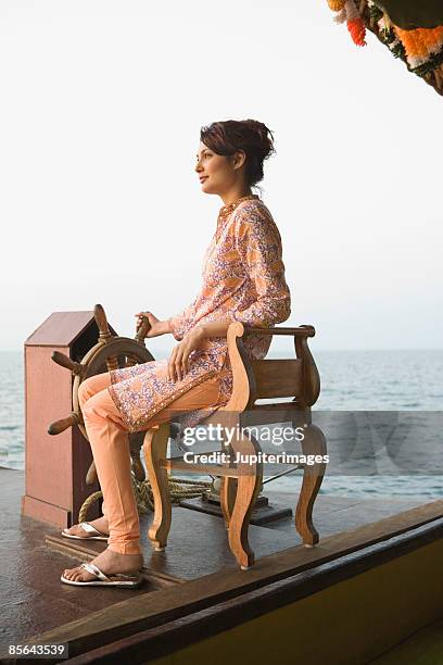 woman navigating houseboat, india - mid adult women stock pictures, royalty-free photos & images