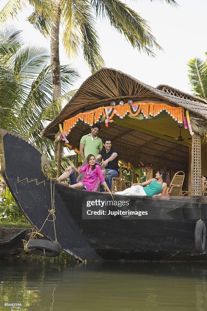 Friends relaxing together on houseboat, India