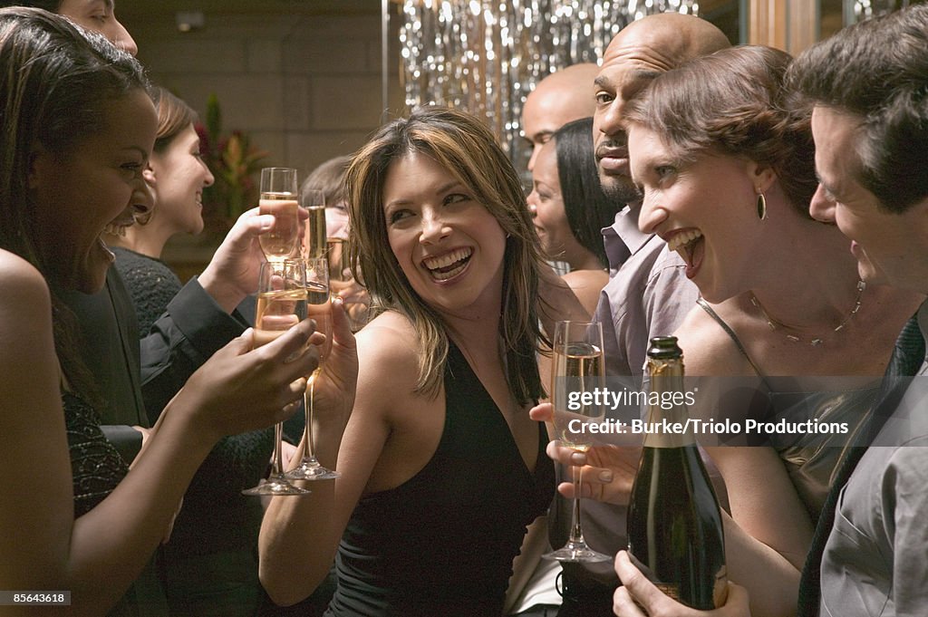 Friends toasting champagne at party