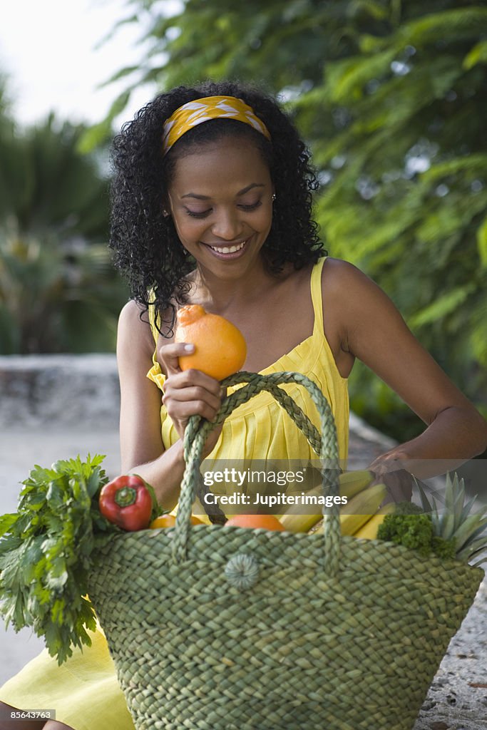 Smiling woman with fresh produce basket