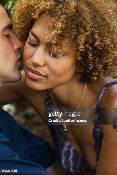 man kissing woman on cheek - black men kissing white women stock-fotos und bilder