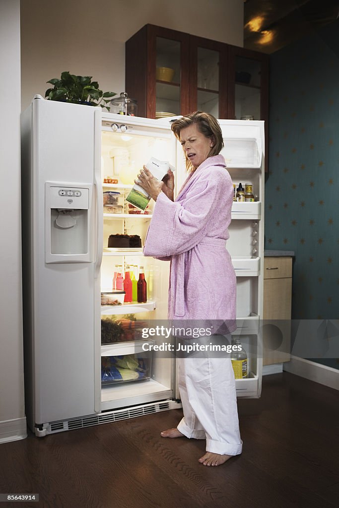 Woman reacting to sour milk