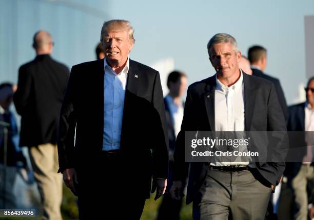 President Donald Trump walks with Jay Monahan, PGA TOUR Commissioner, after the U.S. Team defeated the International Team 19 to 11 in the Presidents...